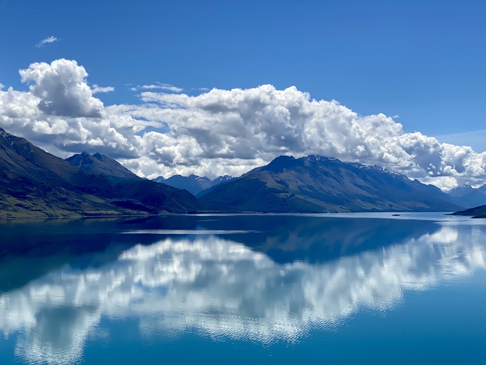 blue and white cloudy sky over lake