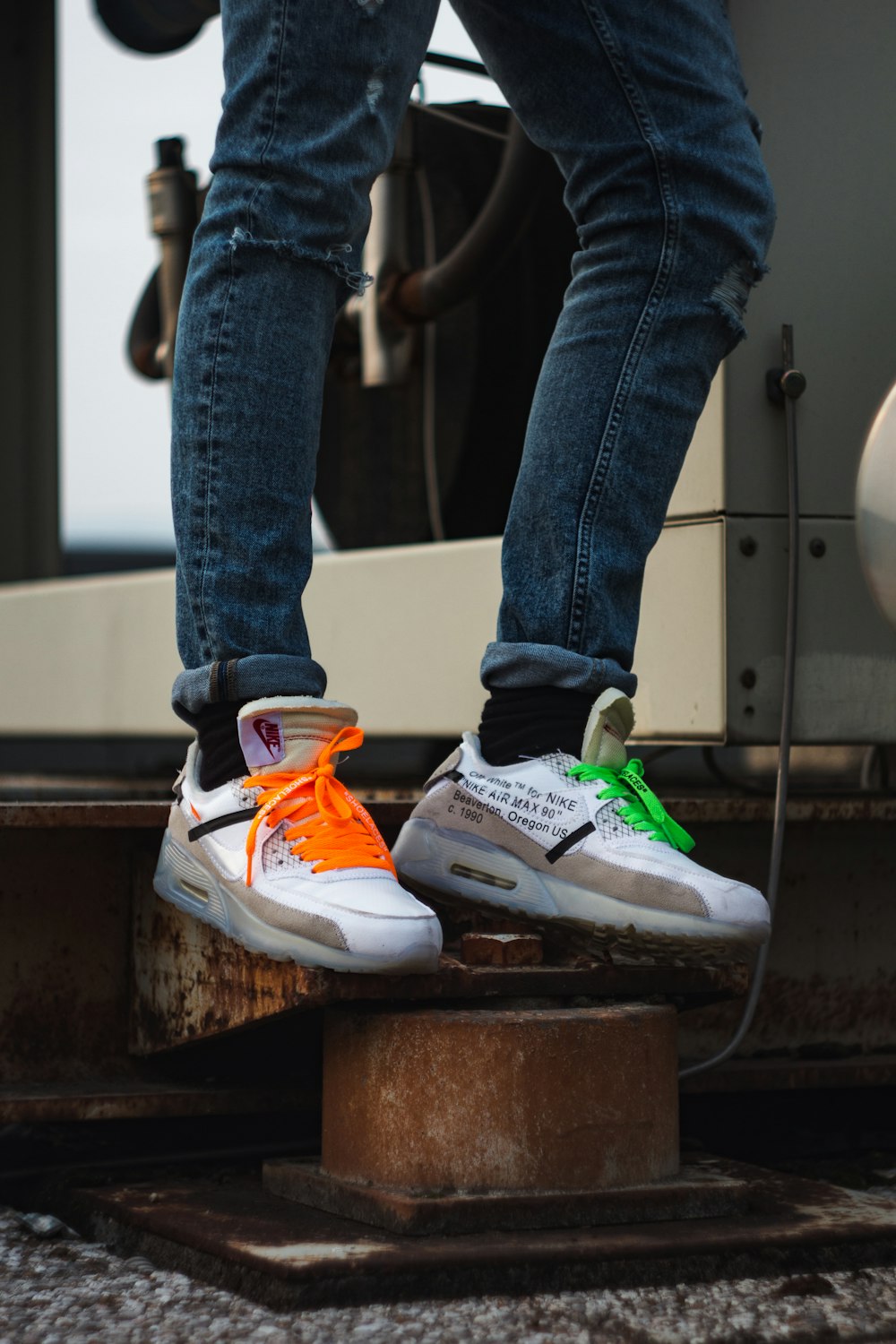 person wearing blue denim jeans and white and orange nike athletic shoes  photo – Free White Image on Unsplash
