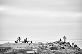 A group of pilgrims pausing for prayer on a quiet bench overlooking rolling hills in the Carolinas.