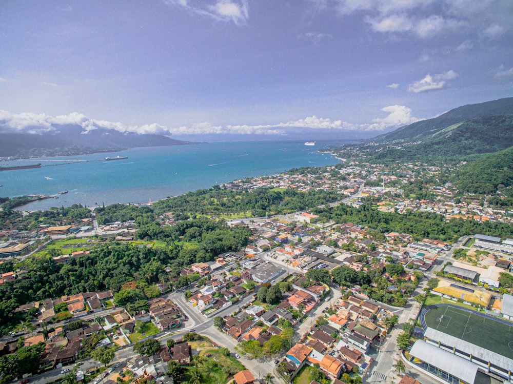 aerial view of city buildings near body of water during daytime