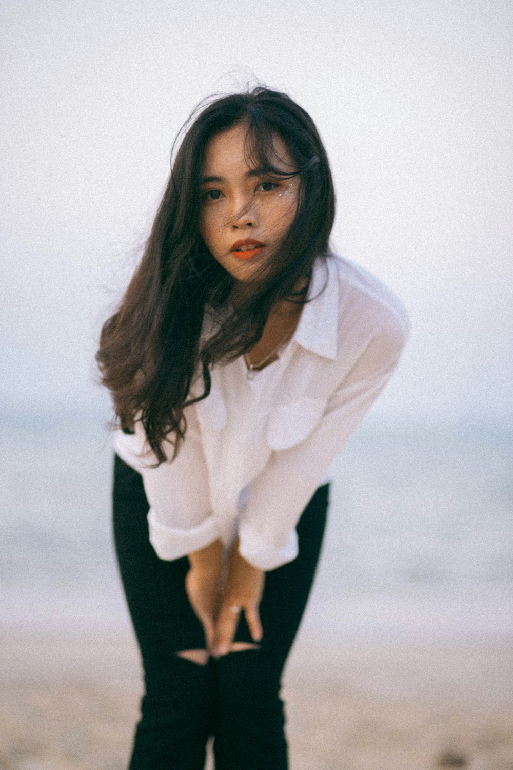 woman in white long sleeve shirt and black pants