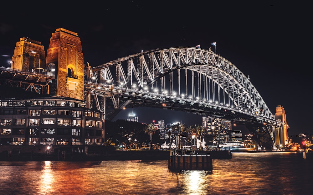 lighted bridge over river during night time