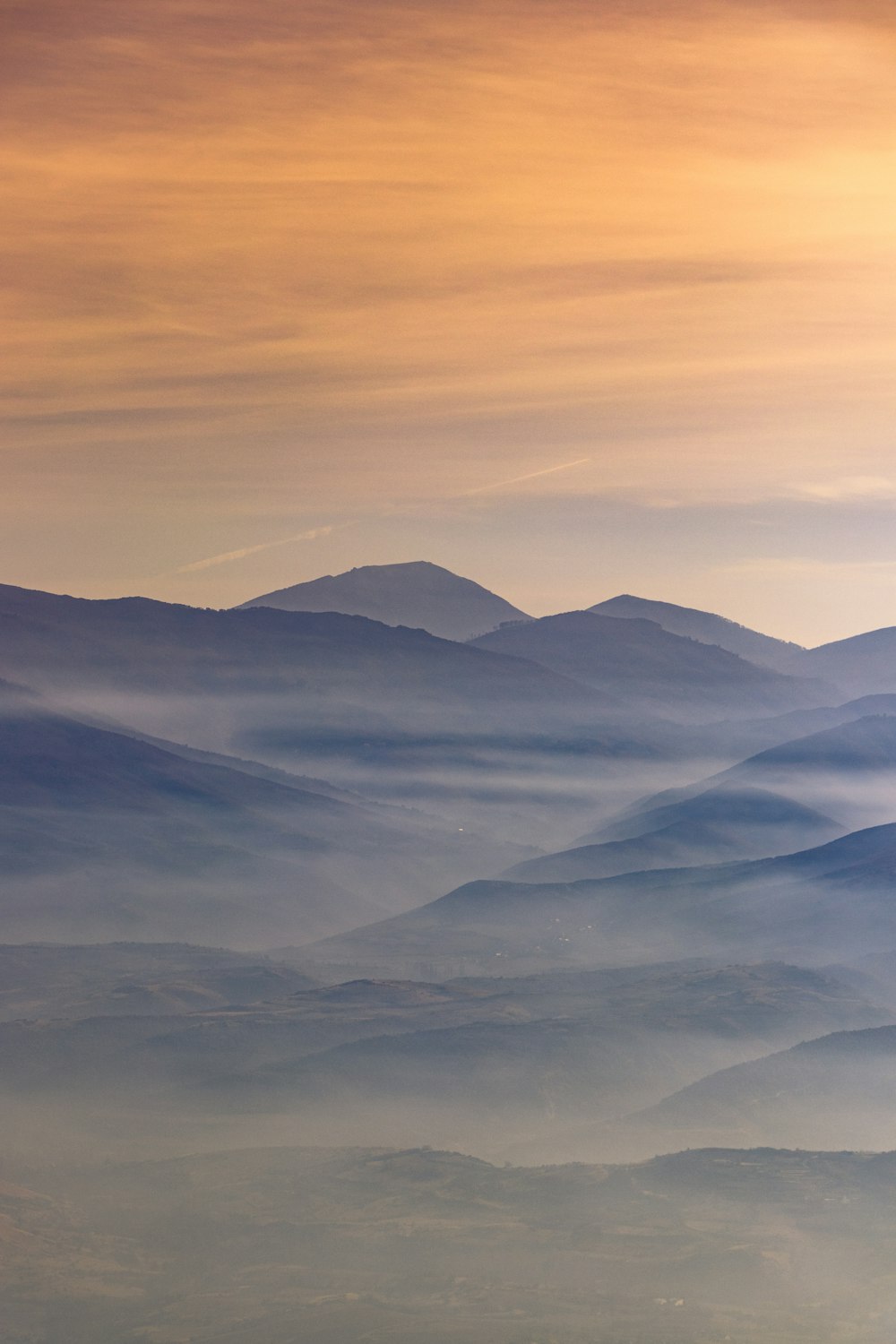 mountains under white clouds during daytime