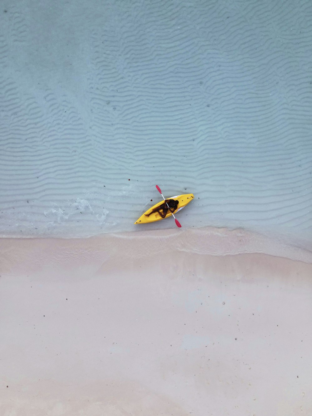 yellow and black surfboard on sea shore during daytime