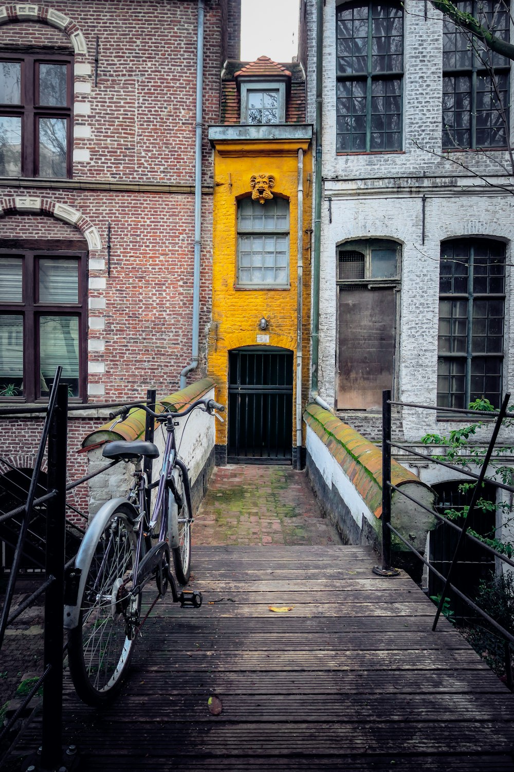 blue city bike parked beside black metal railings