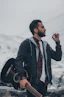 man in black jacket holding black camera