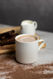Health-conscious person enjoying a cup of magnesium cocoa in a cozy kitchen setting.