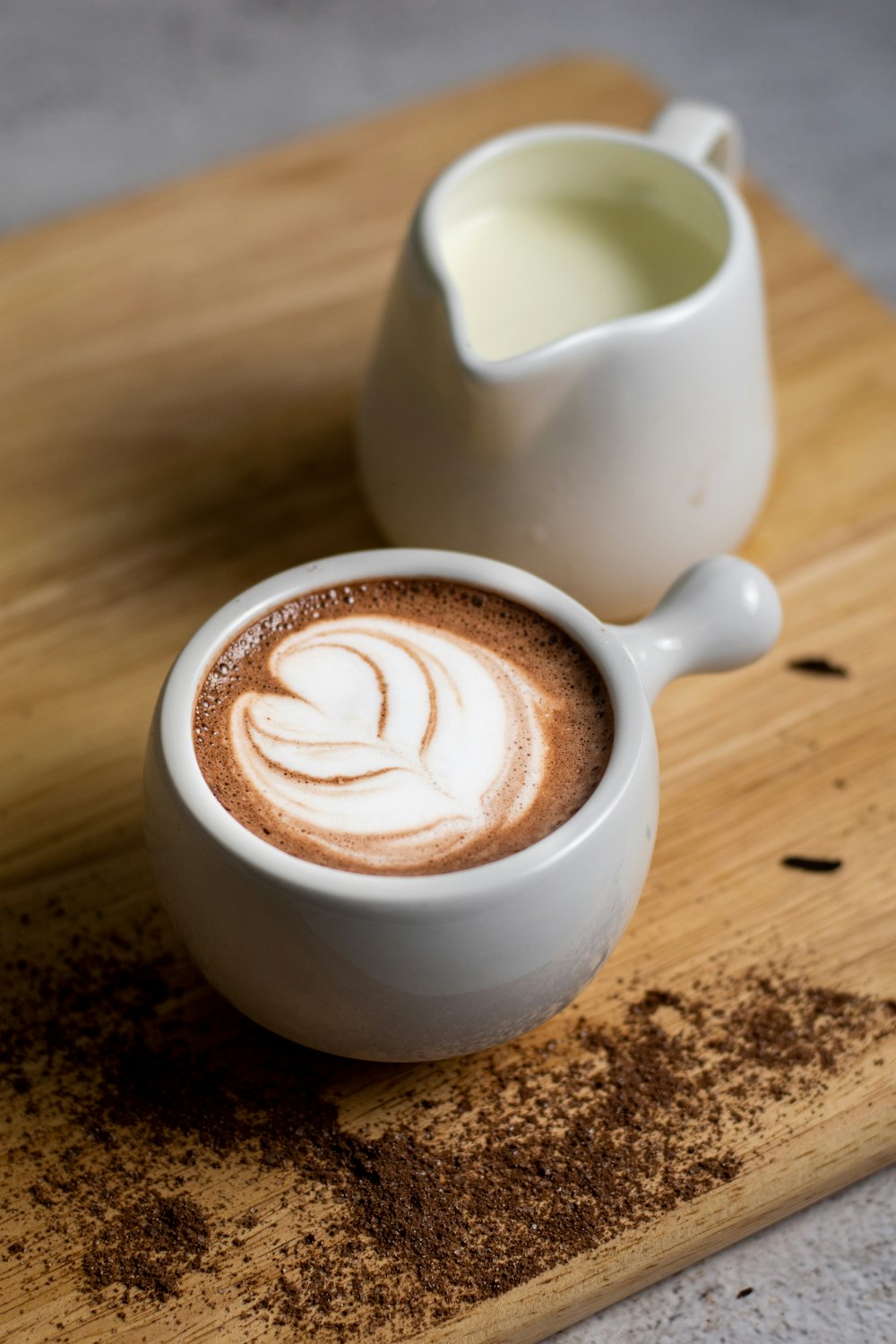 white ceramic cup with heart shaped coffee art