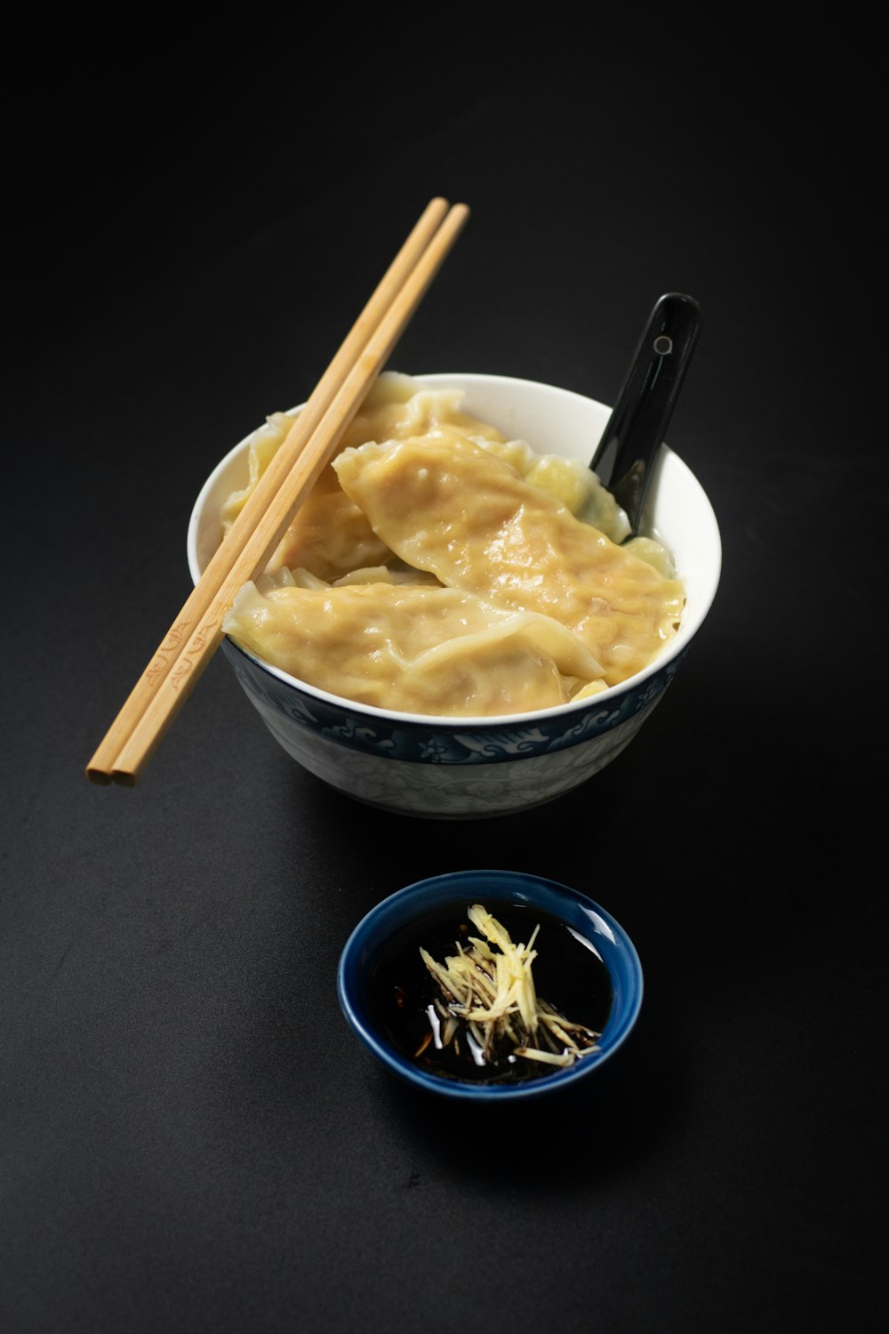 brown wooden chopsticks on blue ceramic bowl