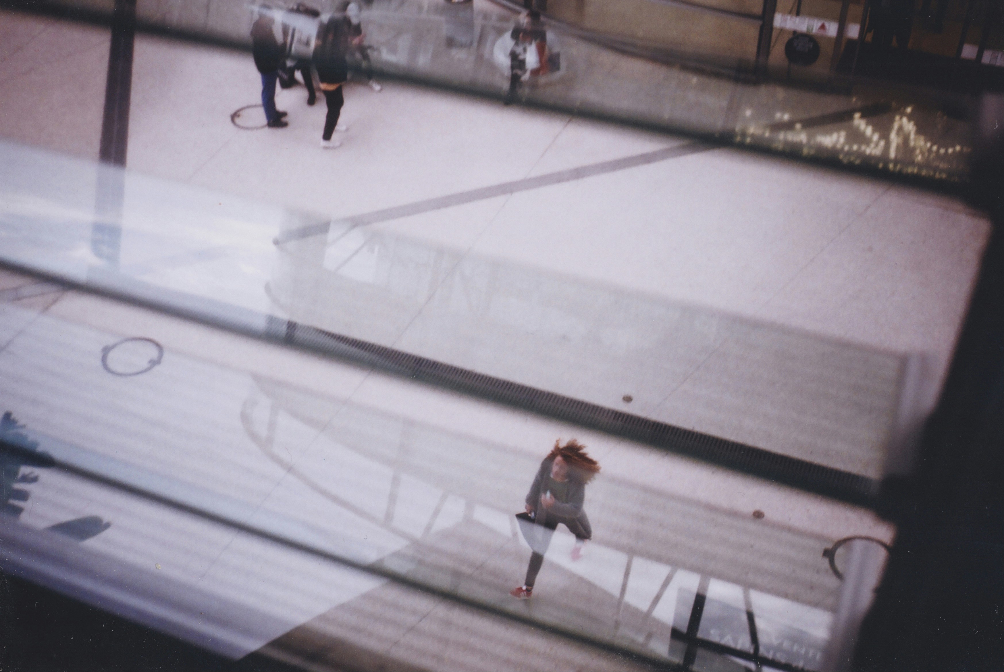 man in white shirt and black pants walking on white floor