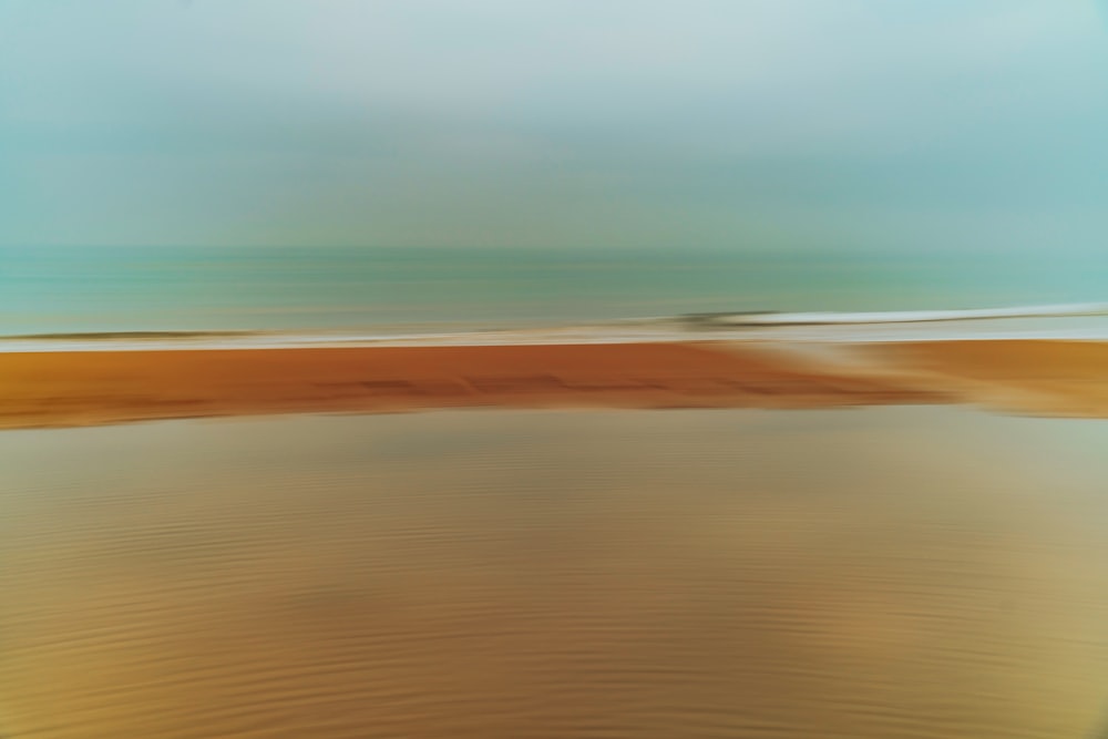 brown sand near body of water during daytime