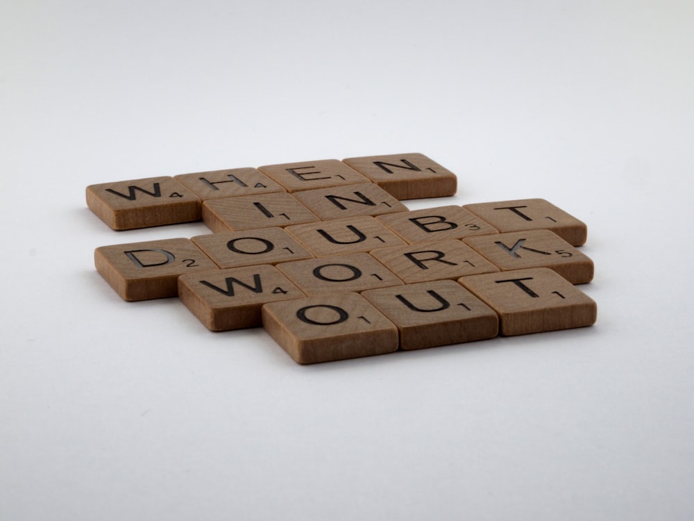 three scrabble tiles with words written on them