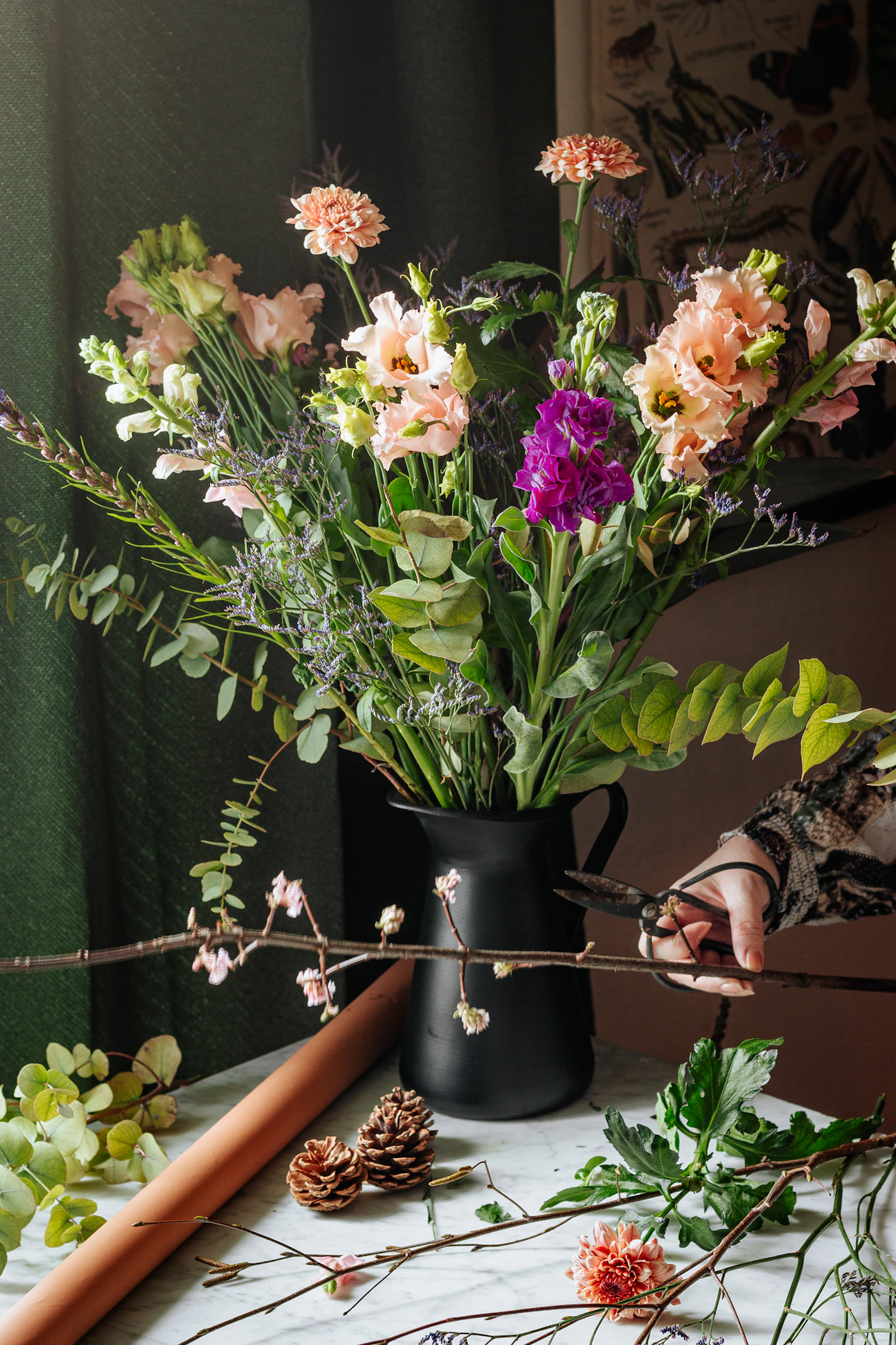 Eloise in the Lilac atelier, arranging silk peonies and ranunculus.