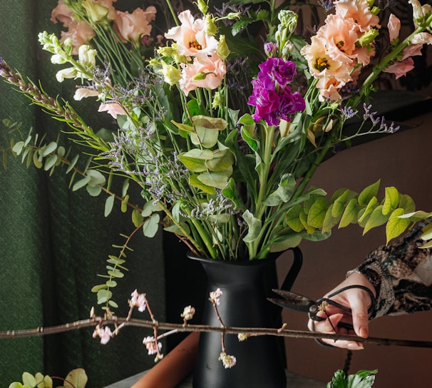 white and purple flowers in black vase