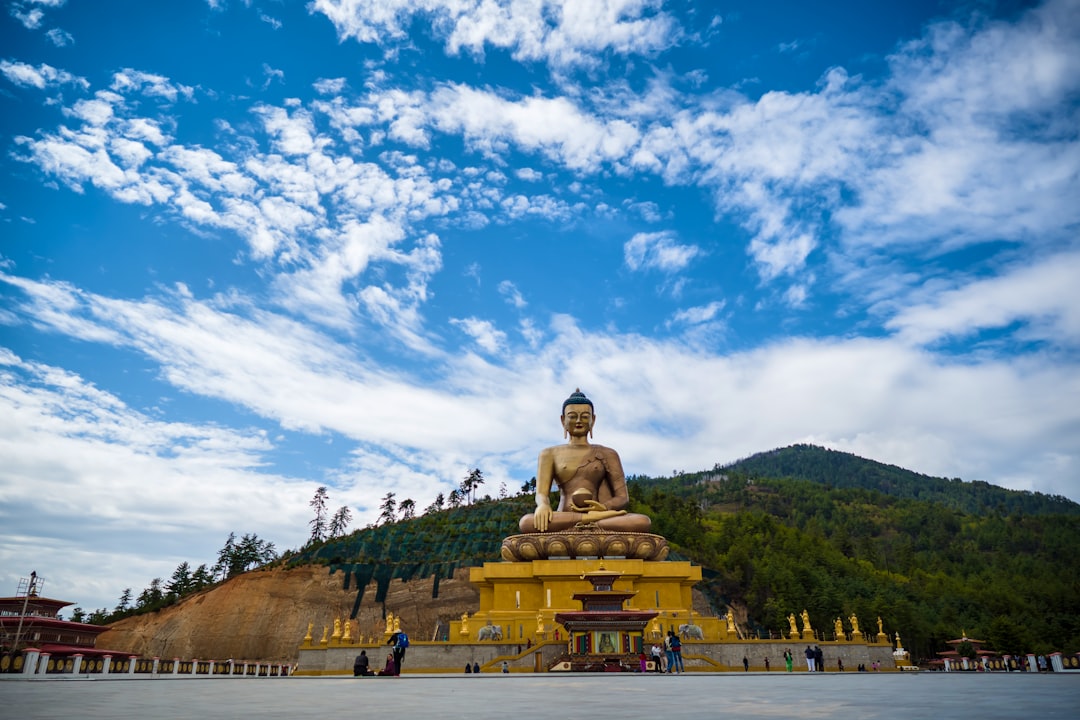 gold buddha statue under blue sky during daytime