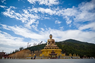 gold buddha statue under blue sky during daytime