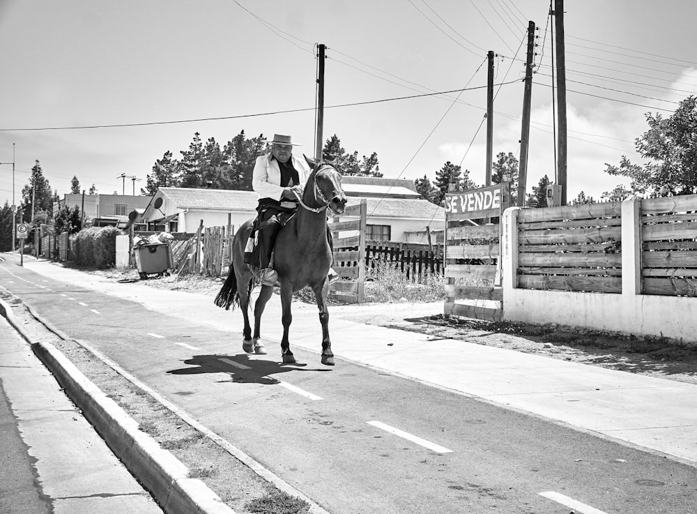 grayscale photo of horse on road