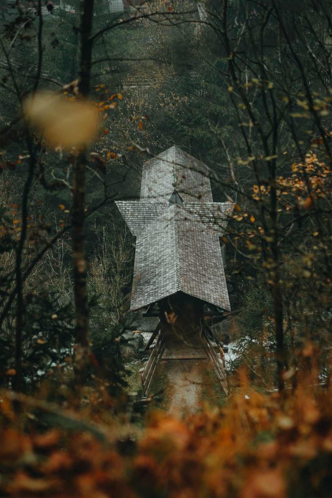 grey concrete cross in the middle of forest during daytime