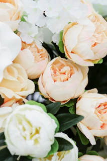 An elegant bridal bouquet with soft pink peonies and trailing greenery