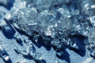 Close-up of crystals reflecting light on a dark surface.