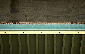 Close-up of a durable neoprene bridge bearing installed on a steel structure.