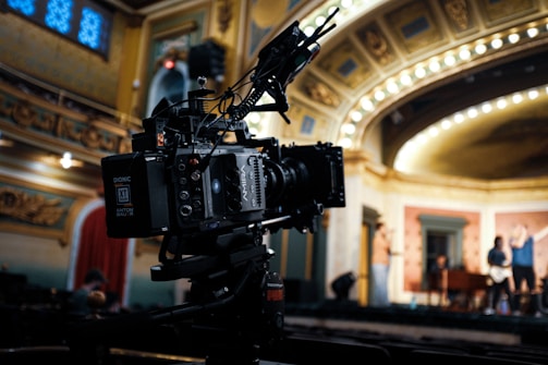 black video camera on black tripod