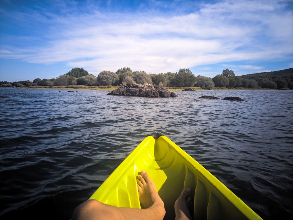 yellow kayak on blue sea during daytime