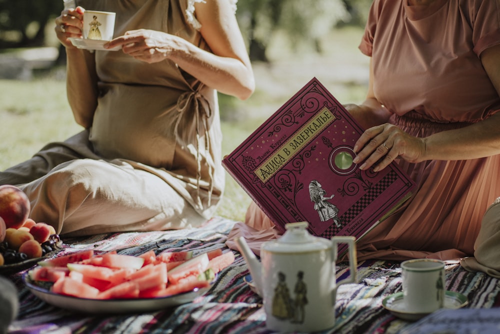 woman in pink dress holding book