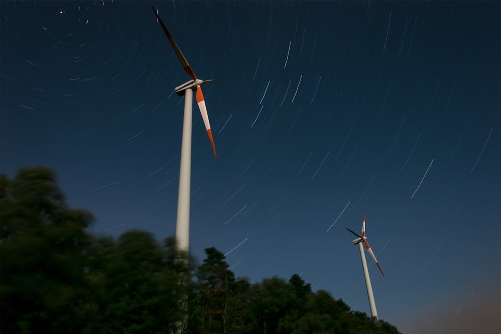 white wind turbine under blue sky during daytime