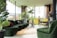 A bright and modern living room with comfortable furniture and large windows.