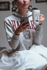 A happy student unlocking the door to their new bedspace near campus, smartphone in hand.