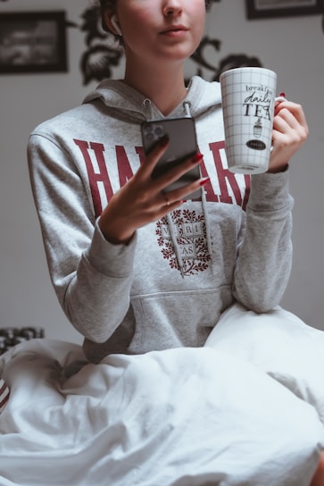 A happy student unlocking the door to their new bedspace near campus, smartphone in hand.