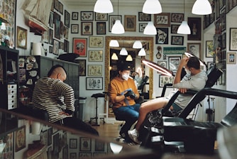 man in orange polo shirt sitting on black leather armchair