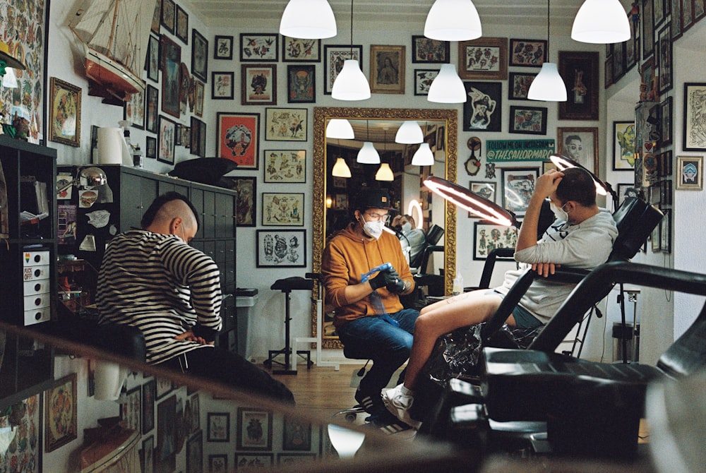 man in orange polo shirt sitting on black leather armchair