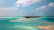 Tourists happily exploring a lush tropical island with crystal-clear waters.