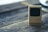 Close-up of detailed miniature Scandinavian furniture on a wooden surface.