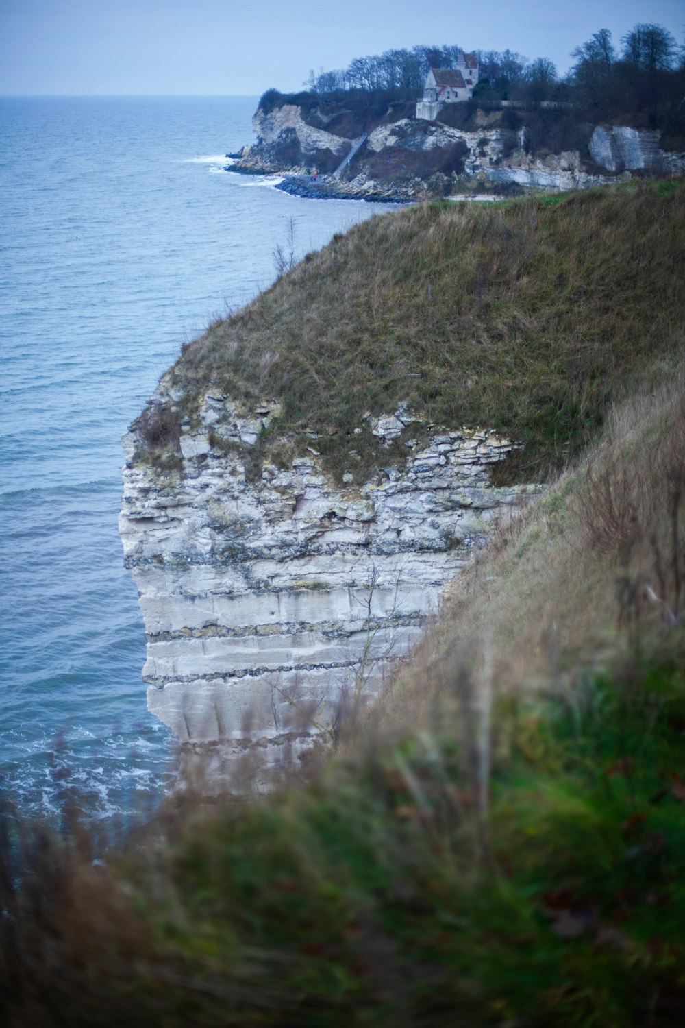 green grass on rocky mountain by the sea