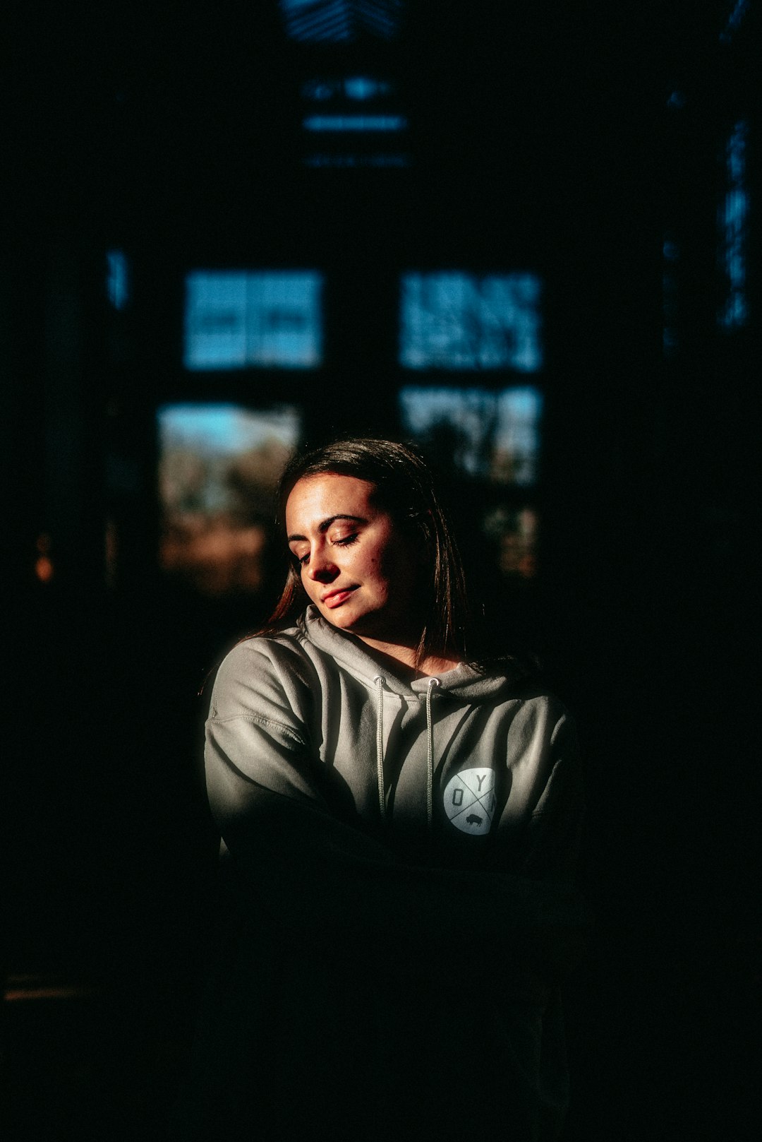 woman in gray hoodie looking at her left side