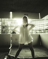 A polished, high-contrast photograph of the founder, Kevin, standing confidently amidst the industrial glamour setting.