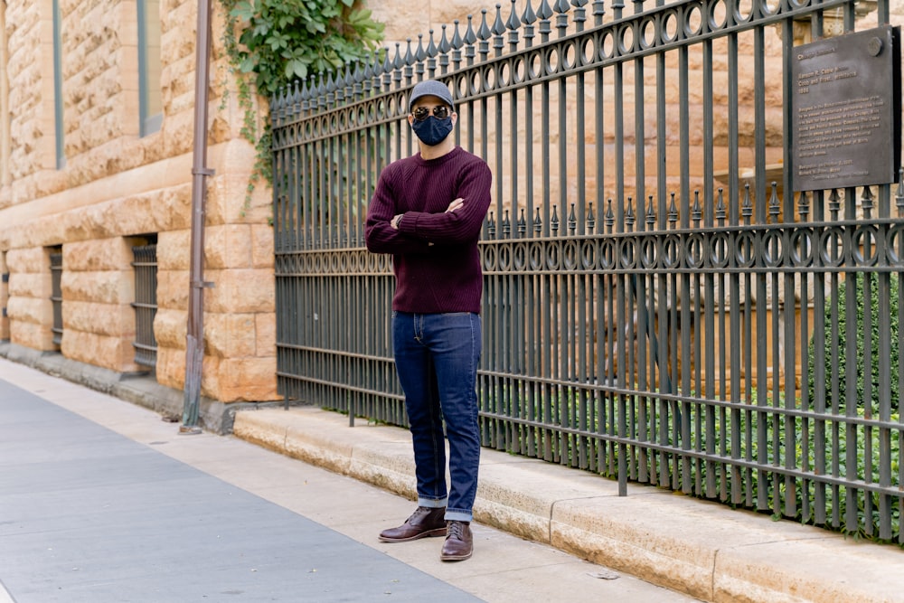 Man in maroon long sleeve shirt and blue denim jeans standing on sidewalk  during daytime photo – Free Chicago Image on Unsplash
