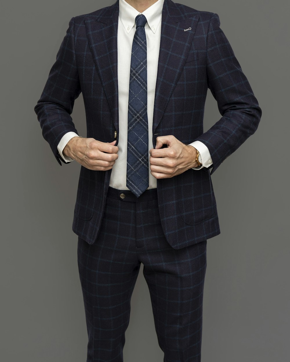 man in black suit jacket and black and white striped necktie