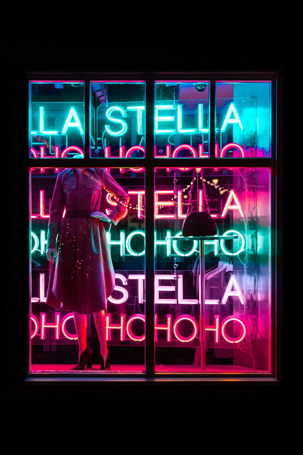 woman in pink dress standing in front of purple neon signage