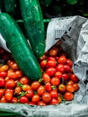green cucumber on white and red fruit print textile
