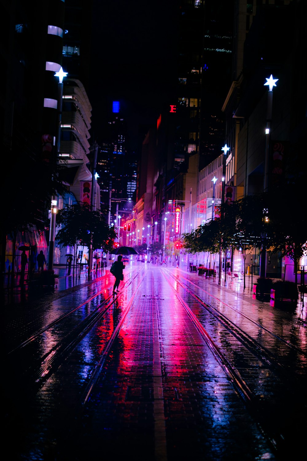 people walking on street during night time