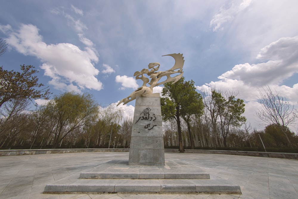 gray concrete statue under blue sky during daytime