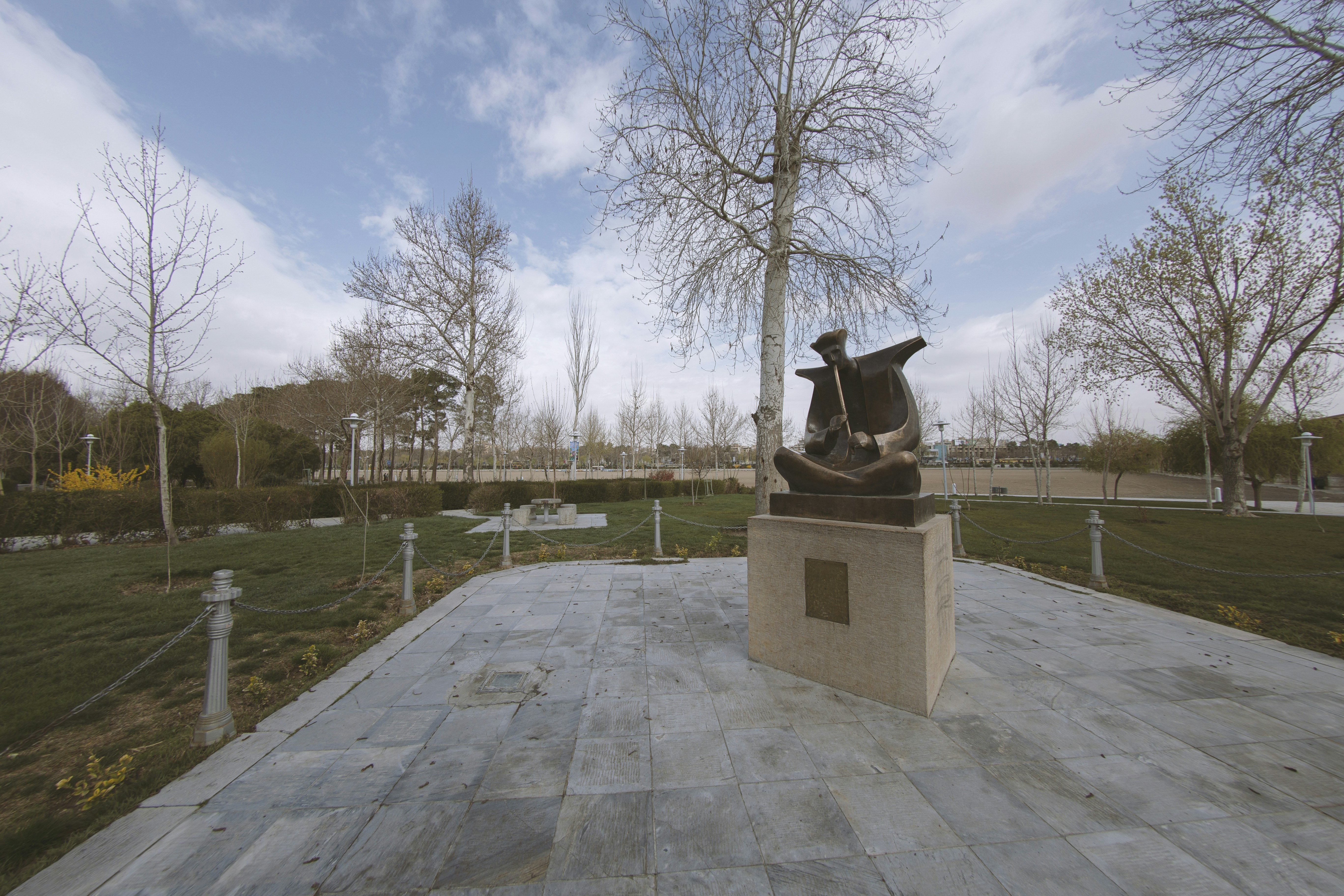 black statue on gray concrete bench
