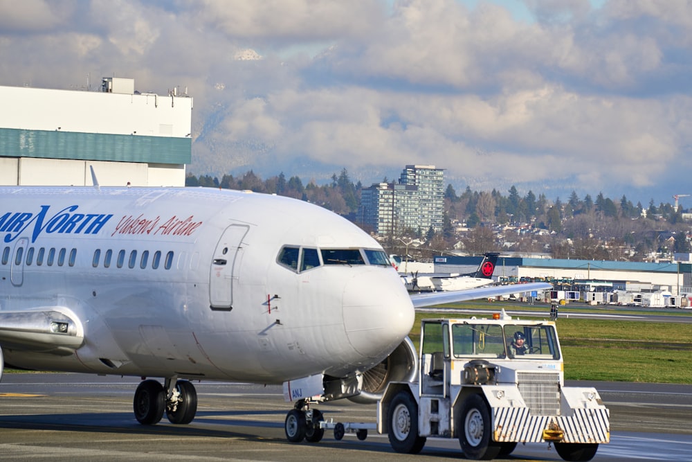 white passenger plane on airport during daytime