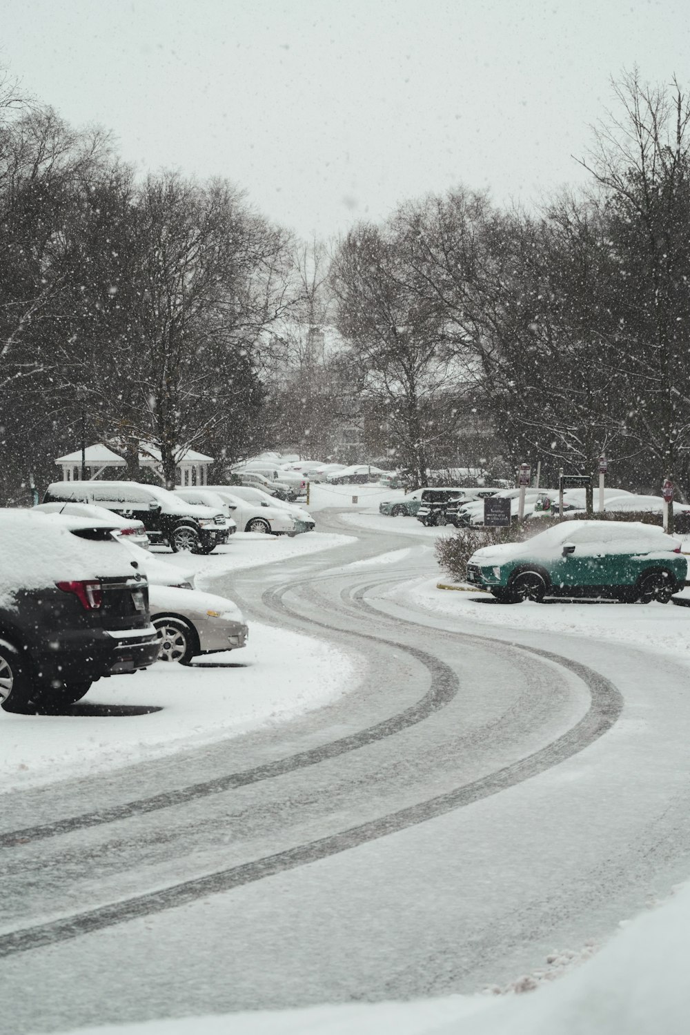 cars on road covered with snow during daytime