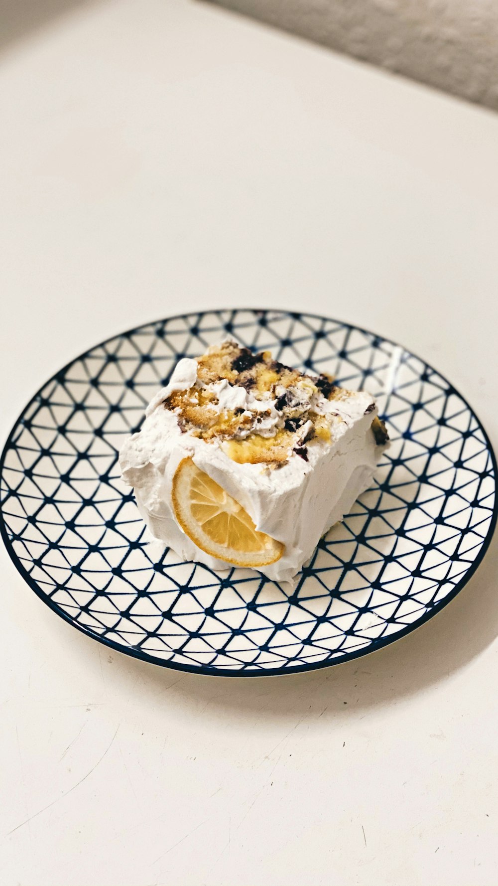 sliced lemon on white and blue ceramic plate