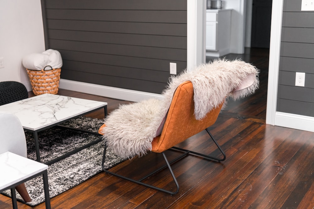 white fur textile on brown wooden chair